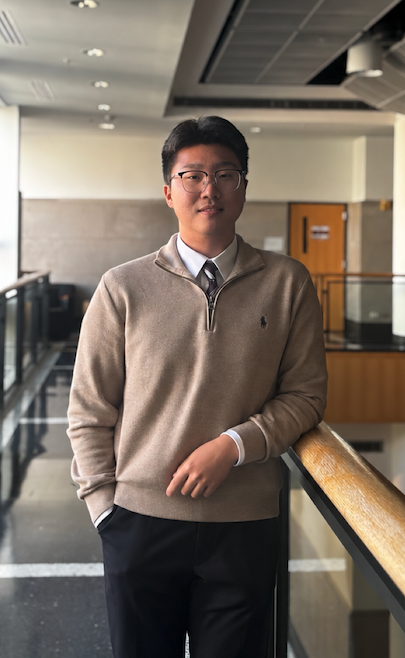 Yongjin (Jin) Hwang standing beside an indoor balcony